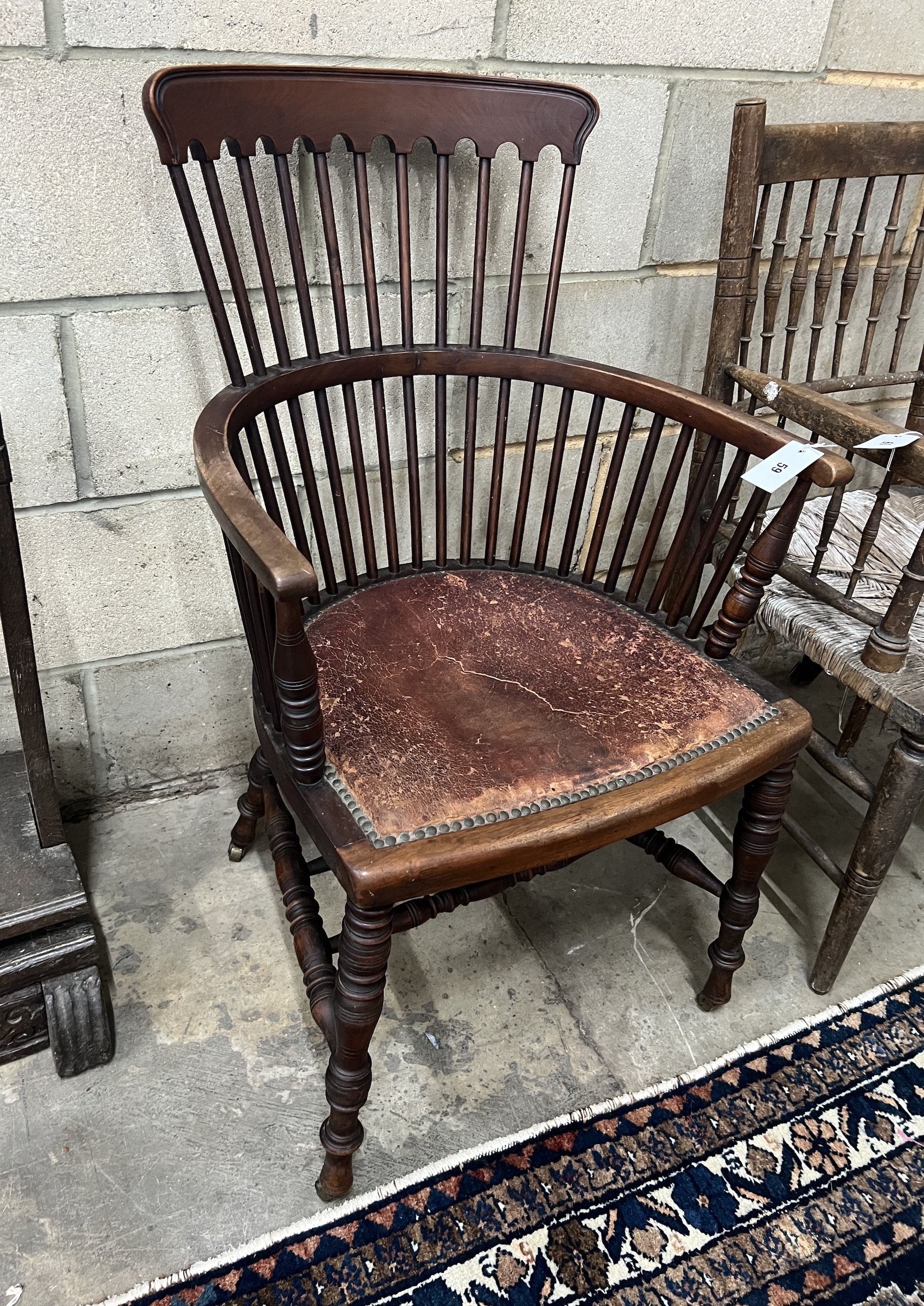In the Manner of James Peddle for E.W. Godwin - A late 19th century mahogany comb back Windsor armchair, width 57cm, depth 46cm, height 92cm
